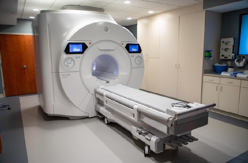GE 3T MRI scanner image for field strength comparison.